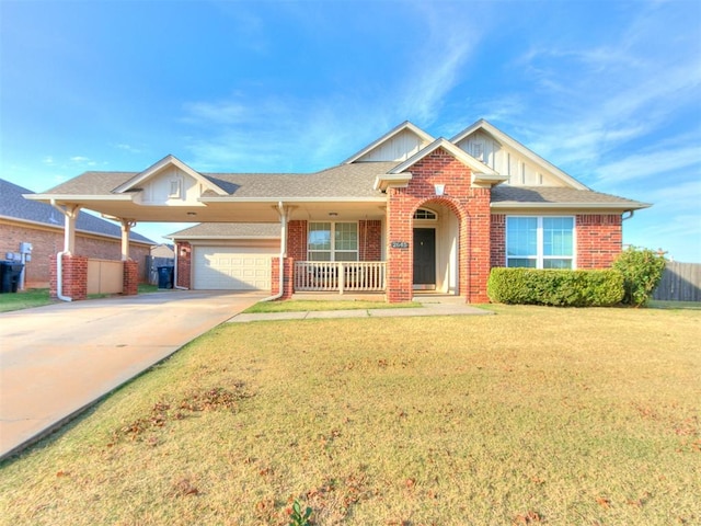 view of front of property with covered porch, a front yard, and a garage