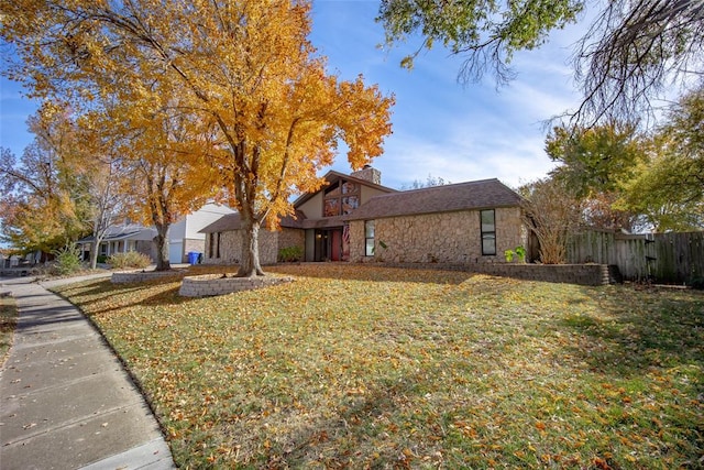 view of side of home with a lawn