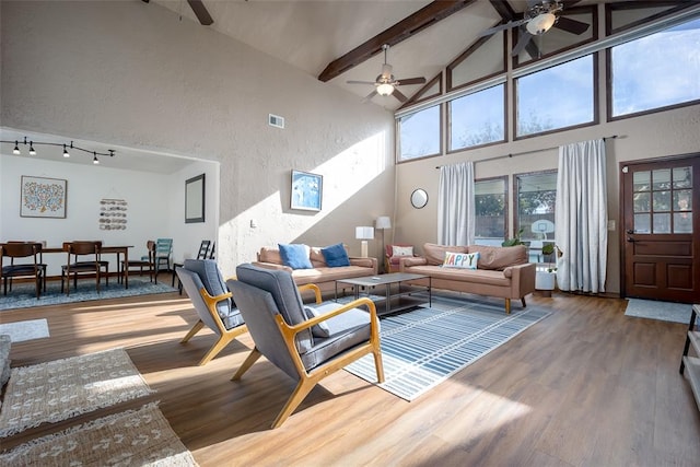 living room with beam ceiling, ceiling fan, high vaulted ceiling, and wood-type flooring