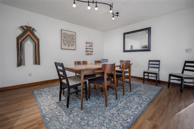 dining space with dark hardwood / wood-style floors