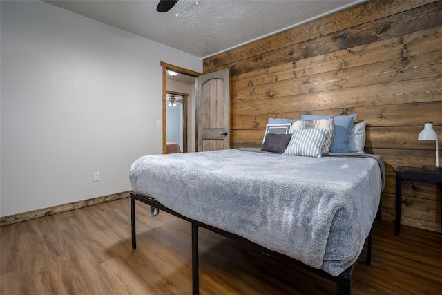 bedroom with hardwood / wood-style flooring and ceiling fan