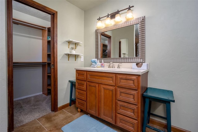 bathroom with tile patterned flooring and vanity