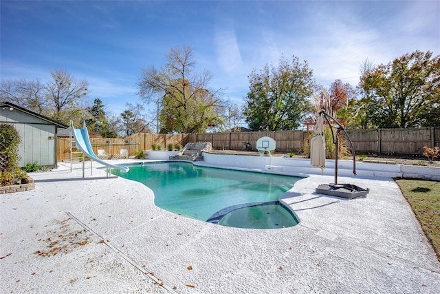 view of pool with a jacuzzi, a patio, and a water slide