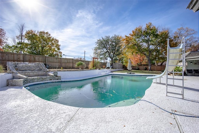 view of swimming pool featuring a patio and a water slide