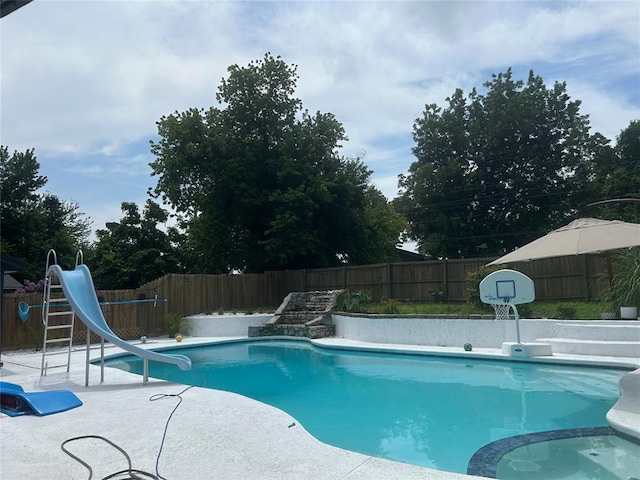 view of pool with a water slide