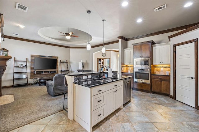 kitchen featuring a center island with sink, ceiling fan, sink, and stainless steel appliances