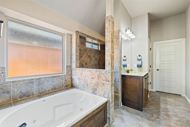 bathroom with a tub to relax in and vanity