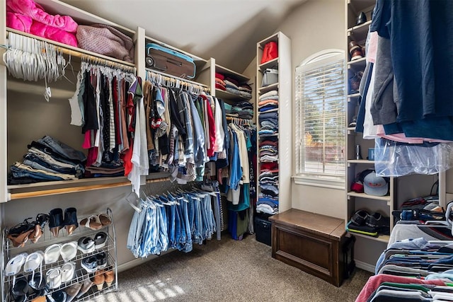 spacious closet featuring carpet floors and lofted ceiling