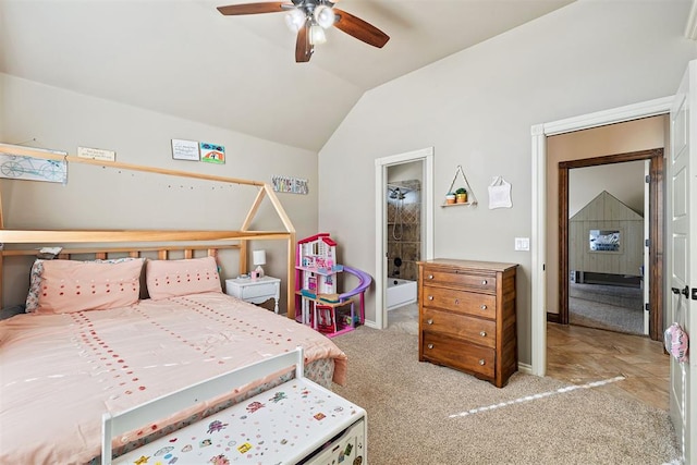 bedroom featuring ensuite bathroom, ceiling fan, light carpet, and vaulted ceiling