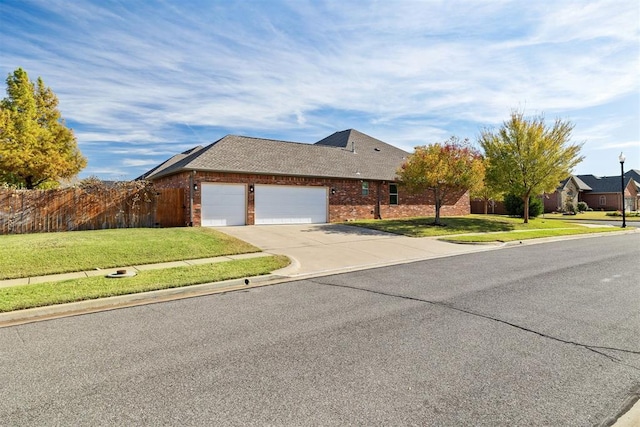 view of front facade featuring a front yard and a garage