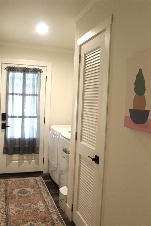 laundry room featuring separate washer and dryer, dark hardwood / wood-style floors, and ornamental molding