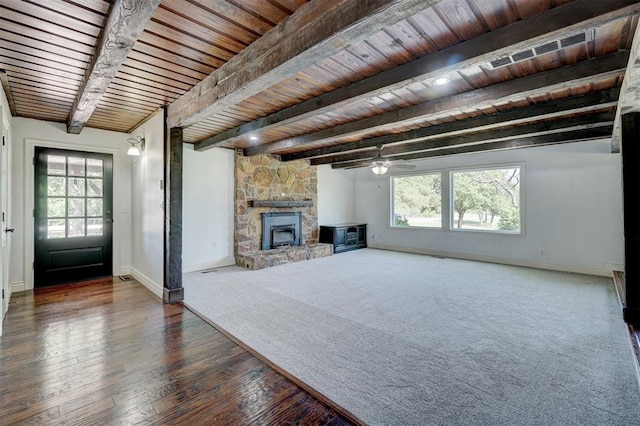 unfurnished living room featuring beam ceiling, ceiling fan, dark hardwood / wood-style flooring, a fireplace, and wood ceiling