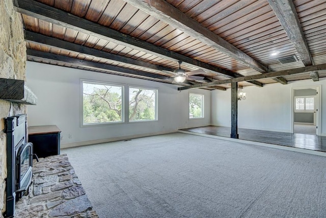 unfurnished living room with carpet flooring, a fireplace, beamed ceiling, and wood ceiling