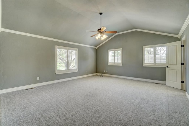 carpeted spare room with ornamental molding, ceiling fan, and lofted ceiling