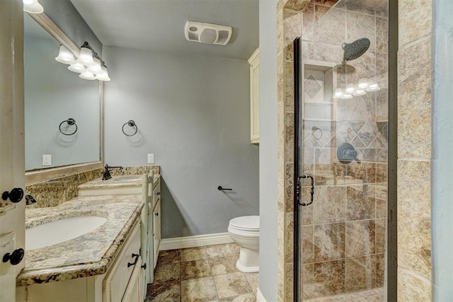 bathroom with toilet, vanity, and walk in shower