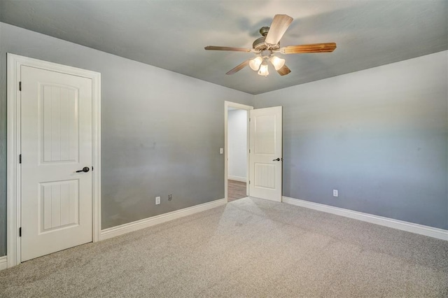 unfurnished room with ceiling fan and carpet floors