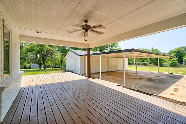 wooden deck featuring ceiling fan and a yard