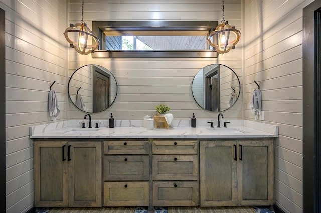 bathroom featuring wooden walls and vanity