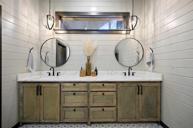 bathroom featuring vanity and wood walls