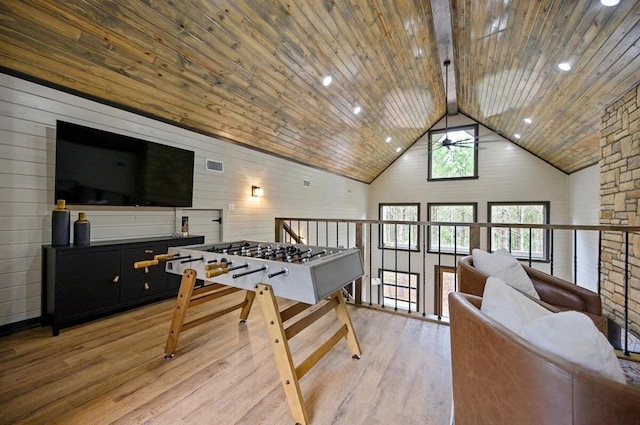 recreation room with high vaulted ceiling, wooden walls, beamed ceiling, light hardwood / wood-style floors, and wood ceiling