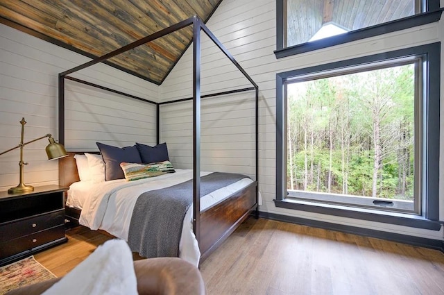 bedroom with hardwood / wood-style floors, wood ceiling, and wooden walls