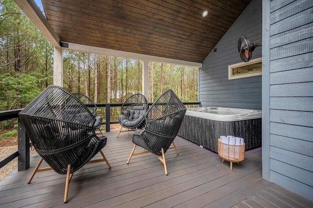 wooden deck with a hot tub