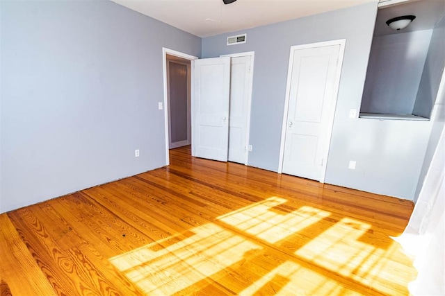 unfurnished bedroom with hardwood / wood-style floors