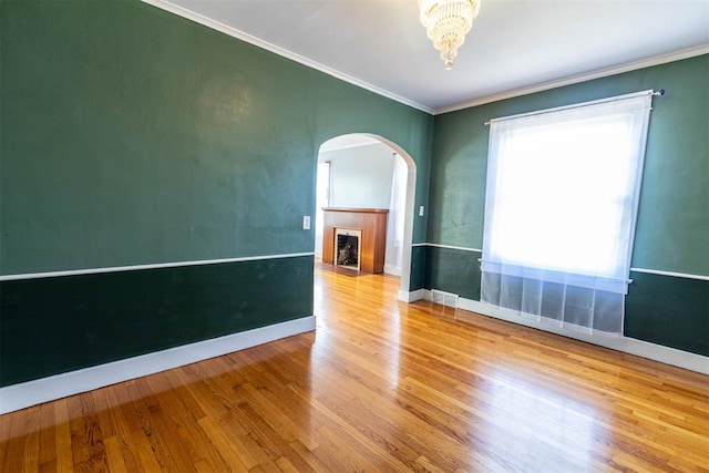 unfurnished room with hardwood / wood-style floors and ornamental molding