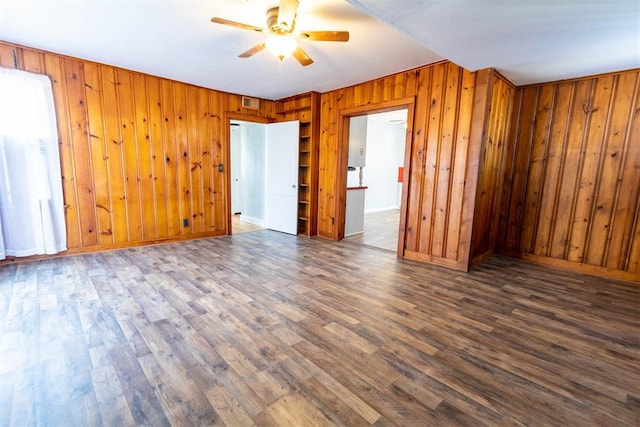 spare room with ceiling fan and dark wood-type flooring