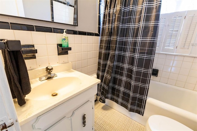 full bathroom with shower / bath combo, vanity, tile walls, tile patterned flooring, and toilet