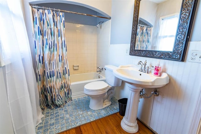 bathroom featuring shower / bath combo, hardwood / wood-style flooring, and toilet