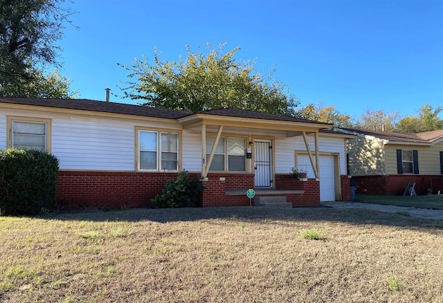 single story home featuring a garage and a front yard