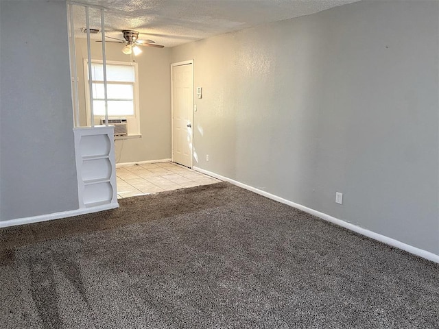 unfurnished room with a textured ceiling, ceiling fan, and light carpet