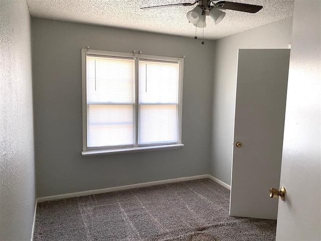 carpeted empty room featuring ceiling fan and a textured ceiling