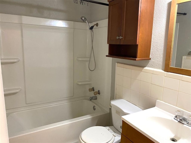 full bathroom featuring  shower combination, vanity, tile walls, and toilet