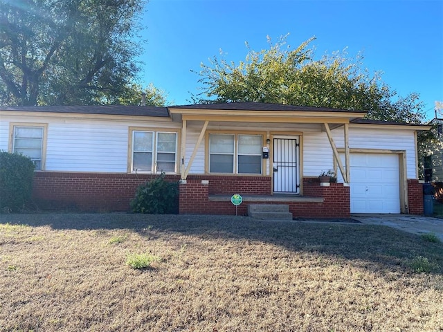 single story home with a garage and a front lawn