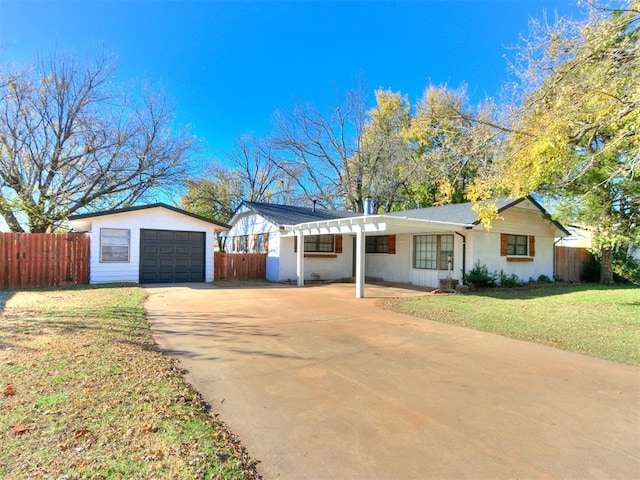 ranch-style house with an outbuilding, a front yard, and a garage