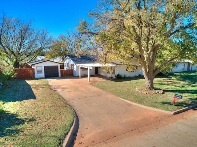 view of front of home with a carport, a front yard, and a garage