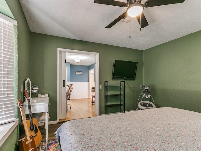 bedroom featuring ceiling fan and hardwood / wood-style floors