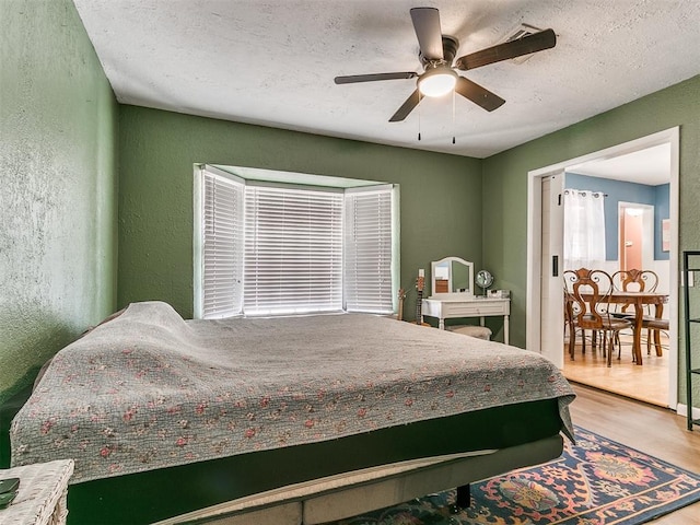 bedroom with hardwood / wood-style flooring and ceiling fan