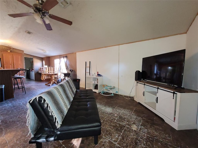 living room featuring ceiling fan and lofted ceiling