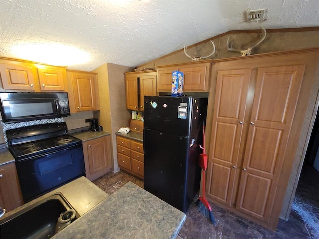 kitchen with black appliances, sink, a textured ceiling, and vaulted ceiling