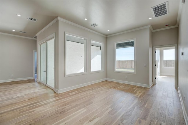 unfurnished room with ornamental molding and light hardwood / wood-style flooring