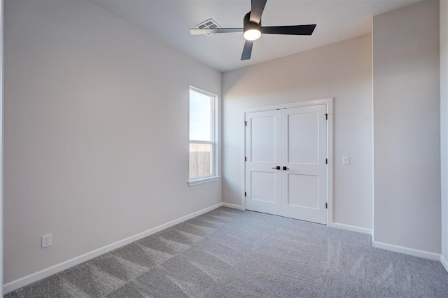 unfurnished bedroom with ceiling fan, a closet, and light colored carpet