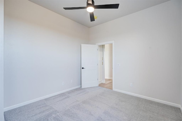 unfurnished room with ceiling fan and light colored carpet