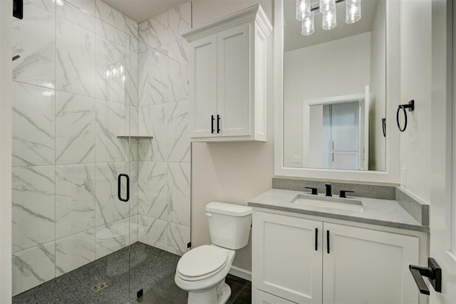 bathroom featuring toilet, an enclosed shower, and vanity