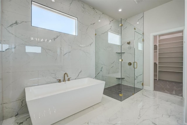 bathroom with tile walls and independent shower and bath