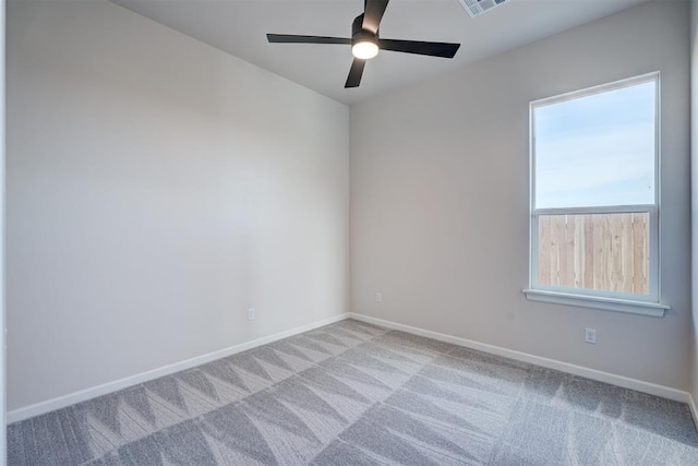 carpeted empty room featuring ceiling fan