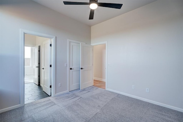 unfurnished bedroom with ceiling fan and light carpet