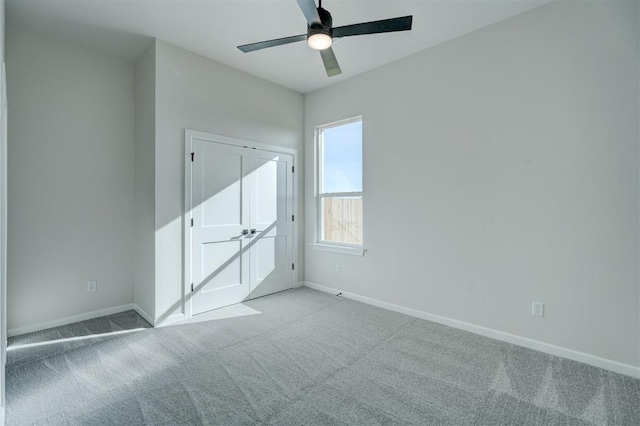 unfurnished bedroom featuring ceiling fan and light colored carpet